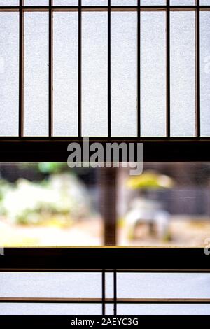 Abstract view of traditional japanese house onsen ryokan hotel in Japan with shoji sliding paper doors and window to green garden Stock Photo