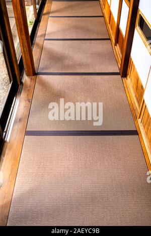 Traditional japanese ryokan house with view above shoji sliding paper doors and brown tatami mat on floor Stock Photo