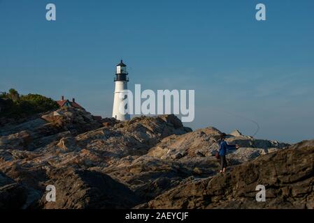 A fly fishing woman on teh coast of maine on a summer evening. Stock Photo