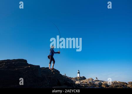 Woman fly fishing on the coast of Maine Stock Photo