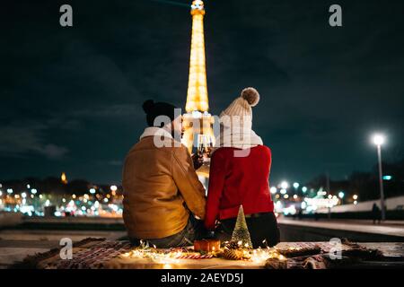 Romantic couple toasting champagne in front of the Eiffel Tower Stock Photo