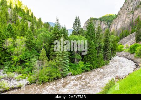 Road highway 133 in Redstone, Colorado during summer with raging crystal river and green trees wide angle landscape high angle view Stock Photo