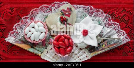 romantic decoration banner  background with sugared almonds on red embroidery Stock Photo