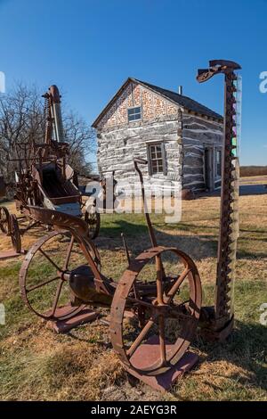 Beatrice, Nebraska - The Palmer-Epard Cabin at Homestead National Monument, with antique farm machinery. Stock Photo