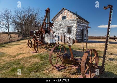 Beatrice, Nebraska - The Palmer-Epard Cabin at Homestead National Monument, with antique farm machinery. Stock Photo