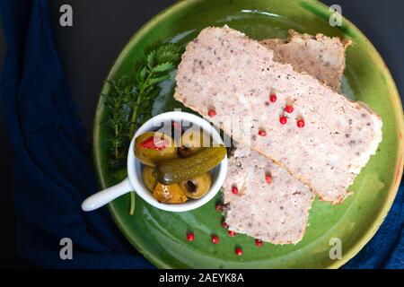 Food appertiser Concept French meatloaf Terrine or pate  in green dish with copy space Stock Photo