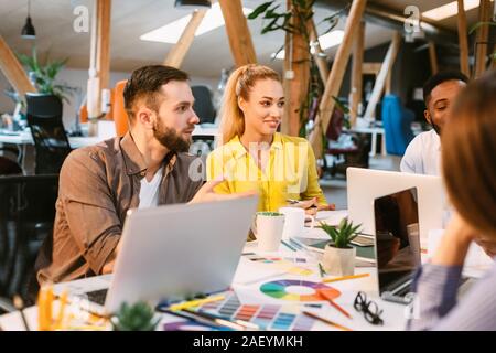 Brainstorming concept. Designers discussing new ideas at meeting in modern office Stock Photo