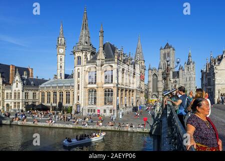 Sightseeing boat with tourists on the river Lys with view over guildhalls at the Graslei / Grass Lane in the city Ghent / Gent, East Flanders, Belgium Stock Photo