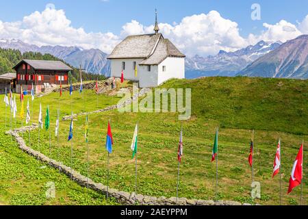 Bettmeralp church and flags in the Swiss Alps, Valais, Switzerland ...