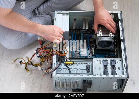 Computer engineer is repairing CPU. Service electronics and computers concept. Stock Photo