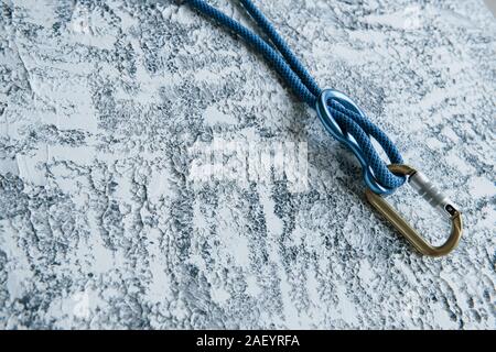 Extreme leisure. Knot with metal carabiner. Silver colored device for the active sports Stock Photo