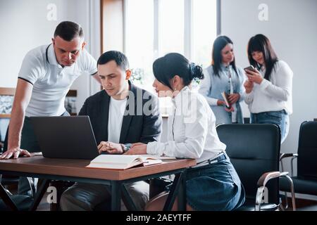 Concentrated at job. Business people and manager working on their new project in classroom Stock Photo