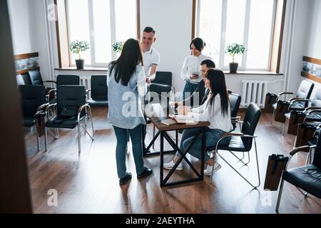 Spacious room. Business people and manager working on their new project Stock Photo