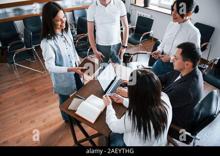 Typing on a keyboard. Business people and manager working on their new project in classroom Stock Photo