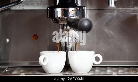 Proffessional brewing - coffee bar details. Espresso coffee pouring from espresso machine. Barista details in cafe Stock Photo