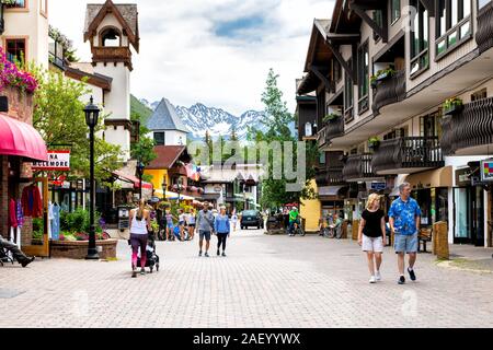 Vail, USA - June 29, 2019: Vacation resort town village in Colorado with people walking shopping by shops on Gore Creek drive Stock Photo