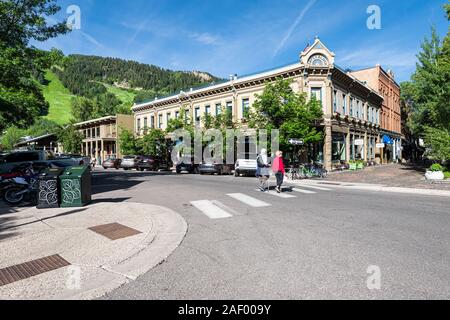 Aspen, USA - July 6, 2019: People older senior couple crossing street in historic downtown outdoor summer street in Colorado Stock Photo