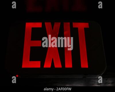 A bright red 'EXIT' sign. Stock Photo