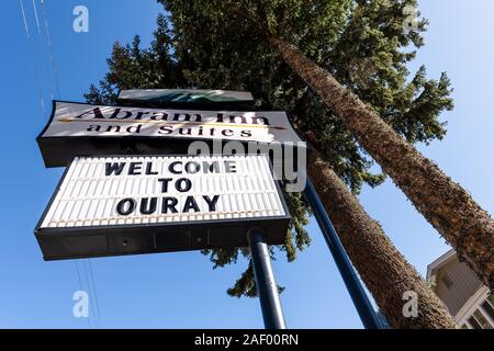 Ouray, USA - September 13, 2019: Small town in Colorado with city main street and wide angle closeup view of inn hotel sign architecture trees Stock Photo