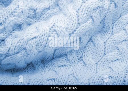 Classic blue knitted fabric wool texture for background. Close up of blue knitted material pattern for design. Blue warm sweater textile background Stock Photo