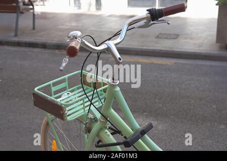 Close-up of a bicycle handlebar parked on the street waiting to be rented by some tourist Stock Photo