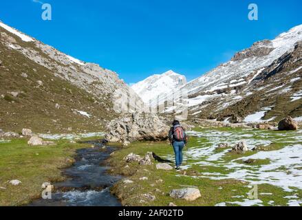 Female hiker walking in Picos de Europa national park in winter. Cantabria, Spin Stock Photo