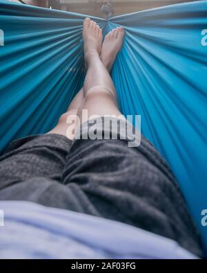 Man lying in a hammock Stock Photo