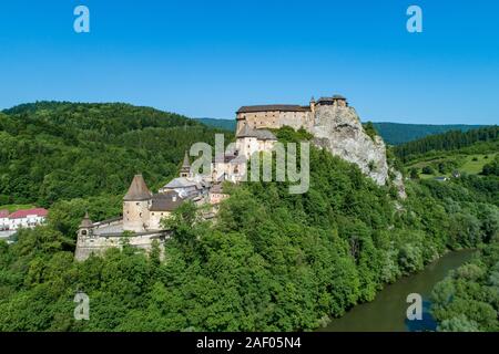 Orava castle - Oravsky Hrad in Oravsky Podzamok in Slovakia. Medieval stronghold on extremely high and steep cliff at Orava river. Aerial view Stock Photo