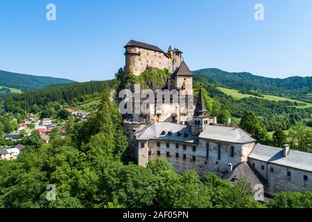 Orava castle - Oravsky Hrad in Oravsky Podzamok in Slovakia. Medieval stronghold on extremely high and steep cliff. Aerial view Stock Photo