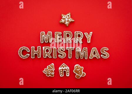 Gingerbread words Merry Christmas on a red background Stock Photo