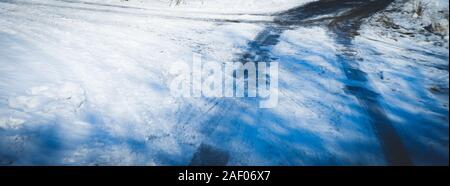 Winter rural country road. Difficult weather conditions with ice and sleet. Unfocused blurred photo. Stock Photo