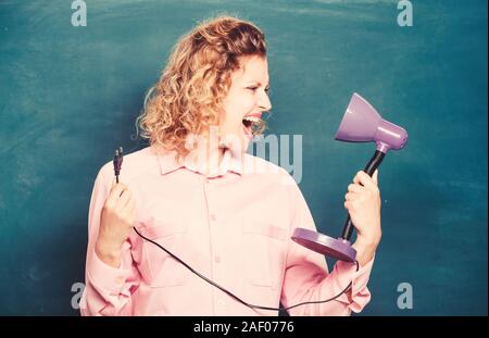 Teacher hold table lamp in hand chalkboard background. Knowledge day. Light up process of studying. Insight and idea. Educational idea. Woman work on bright shiny idea. Creativity and inspiration. Stock Photo