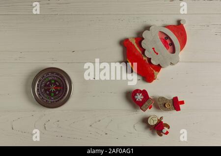 compass points where Santa lives: compass and christmas figurines are on white background Stock Photo