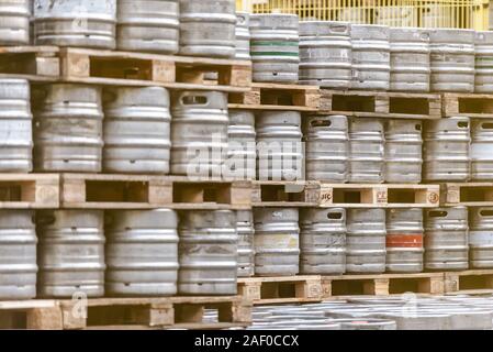 Beer barrels. Beer factory. Beer warehouse. Racks of beer barrels on pallets. Stock Photo