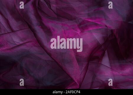 Background fabric folds lilac pink tulle or organza, selective focus Stock Photo