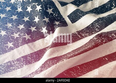 Blue monochrome grungy American flag with stars and stripes and red light leak printed on white fabric Stock Photo