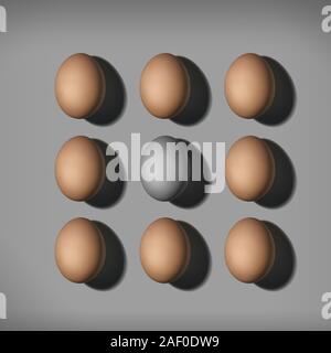 Top view of brown eggs and gray egg in center. Colorless egg between brown colored eggs Stock Photo