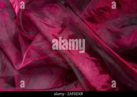 Background fabric folds lilac pink tulle or organza, selective focus Stock Photo