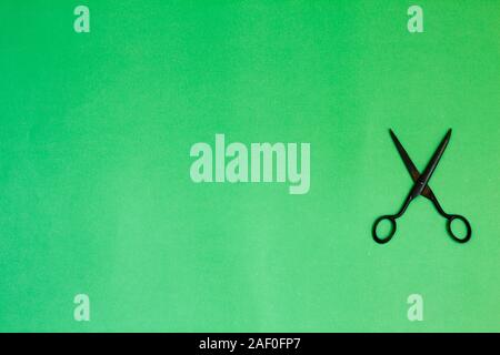 Single old soviet scissors isolated on green background Stock Photo