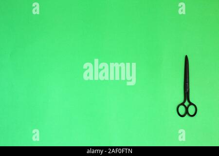 Single old soviet scissors isolated on green background Stock Photo