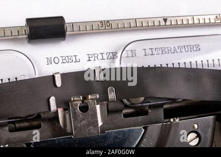 The inscription 'nobel prize in literature' on a white sheet in a typewriter. Nobel prize in literature. Light background. Stock Photo
