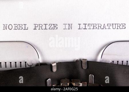 The inscription 'nobel prize in literature' on a white sheet in a typewriter. Nobel prize in literature. Light background. Stock Photo