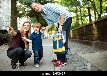 Parents walking son to preschool or daycare Stock Photo