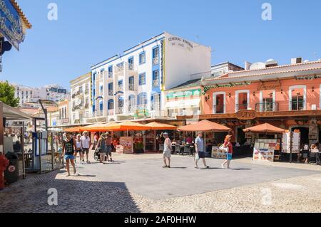 Albufeira, Portugal - September 3, 2014: Tourists visit town square with shops, bars and restaurants in the tourists town of Albufeira in Algarve regi Stock Photo