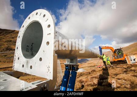 3 wind turbines being constructed behind the kirkstone Pass Inn on kirkstone Pass in the Lake District, UK. Because of its remote location, the pub is Stock Photo