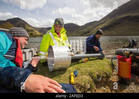 Dr Jeff Warburton of Durham university preparing to take sediment cores from the bottom of Buttermere Lake in the Lake District National Park as part Stock Photo
