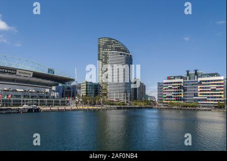 Melbourne, Australia - November 16, 2009: Ethiad Stadium and modern highrise building with colorful facades of retail and residential buildings under Stock Photo