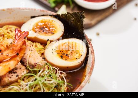 close up view of spicy seafood ramen with shrimps in bowl Stock Photo