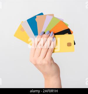 cropped view of woman holding colorful credit card templates in hand isolated on white Stock Photo