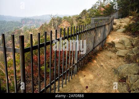 Rugged nature trail with an iron fence for safety precautionary measures at Tallulah Gorge state park in Tallulah Falls Georgia USA. Stock Photo